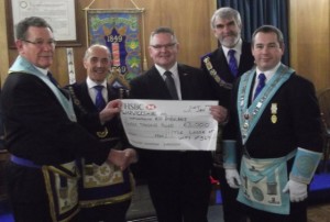 W Bro Watson presents a cheque for £3,000 to Stuart Wilkins for the Warwickshire & Northants Air Ambulance